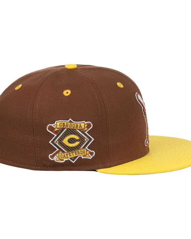 The Cordoba Cafeteros EFF DNA Fitted Ballcap by EFF is a vintage-inspired brown and yellow cap with a yellow brim and an embroidered Córdoba Cafeteros patch, celebrating Mexican League heritage.