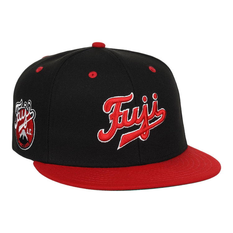 The Fuji Athletic Club EFF DNA Fitted Ballcap by EFF is a vintage-inspired black and red cap featuring bold Fuji embroidery, a round Fuji A.C. logo patch on the side, and a striking red brim and button.