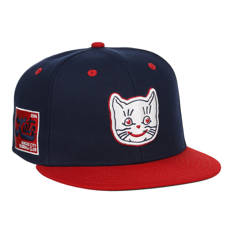 The Kansas City Katz EFF DNA Fitted Ballcap by EFF is a vintage-inspired navy cap with a red brim, Katz embroidered logo, and a 1961, Kansas City Baseball Club patch on the side.
