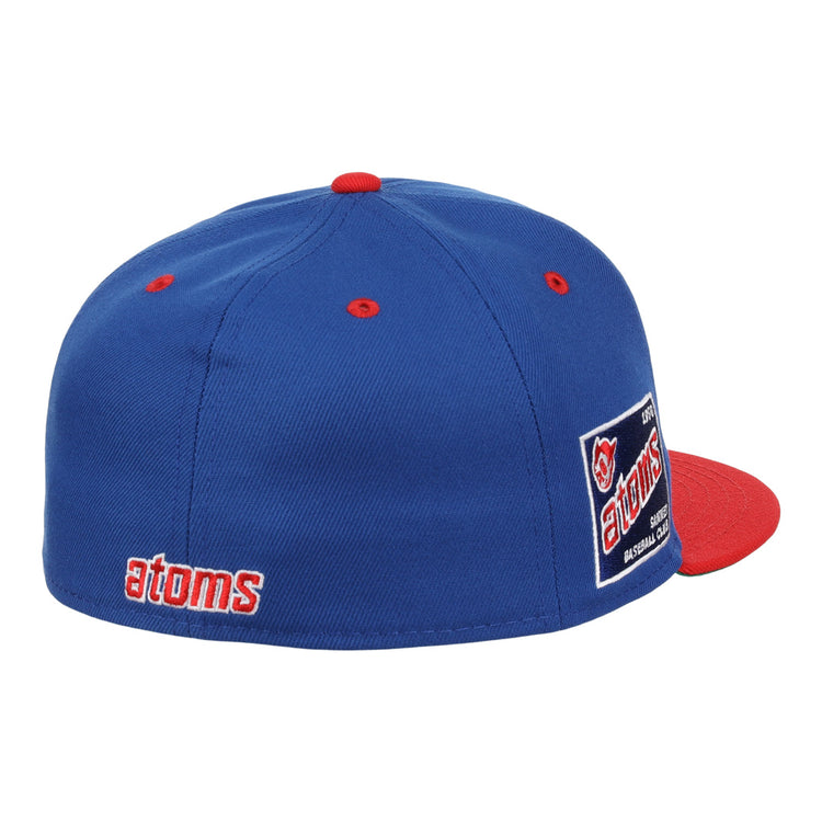 The Sankei Atoms EFF DNA Fitted Ballcap by EFF features blue vintage styling with a red button and brim, atoms embroidered in red and white on the side, an atoms logo patch on the back, and classic Ebbets Field Flannels craftsmanship.