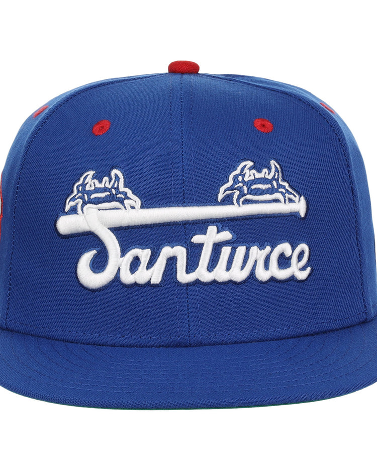 The EFF Santurce Cangrejeros NLB Team Color Fitted Ballcap is a vintage-inspired blue cap with “Santurce” in white script and crab graphics, celebrating the Puerto Rican League legacy.