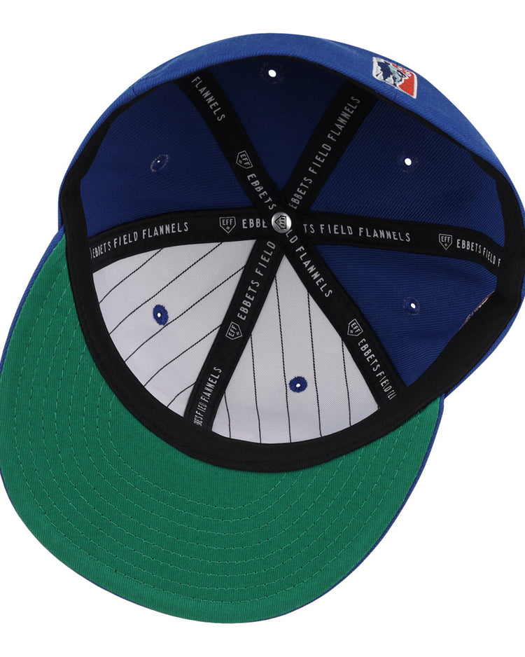 The EFF Indianapolis Clowns NLB Team Color Fitted Ballcap features a blue crown, green underbill, black sweatband, gray pinstriped lining, and EFF branding—paying tribute to the historic Indianapolis Clowns.