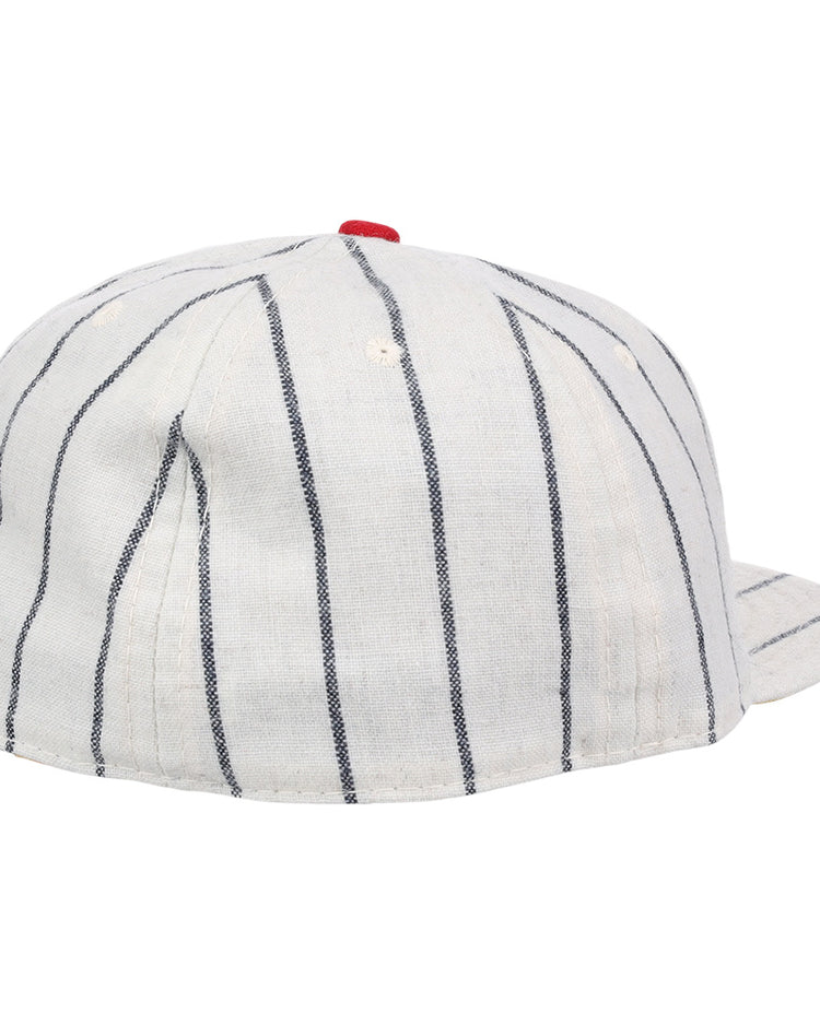 The Limited Edition Newark Peppers 1915 Vintage Ballcap by Ebbets Field Flannels features white fabric with black pinstripes and a small red top button, shown from the back and slightly to the side.