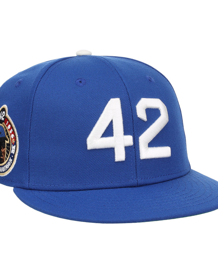 The EFF Jackie Robinson Signature Series Royal Fitted Ballcap features a white 42 on the front and a side patch with Jackie Robinson’s image and number—honoring his enduring legacy.