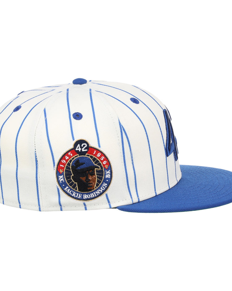 The EFF Jackie Robinson EFF Signature Series Fitted Ballcap - Pinstripe features blue pinstripes, a blue brim, and a circular Jackie Robinson tribute patch with 42 and his silhouette.