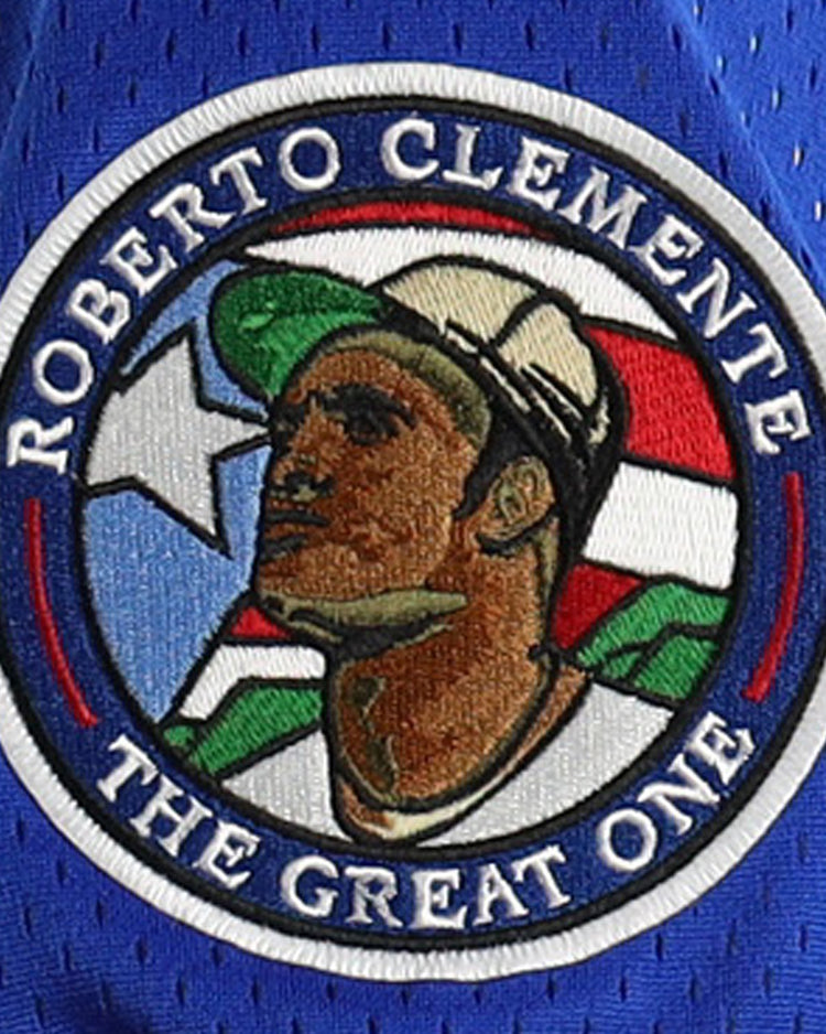 The EFF Roberto Clemente Santurce Cangrejeros NL Replica V-Neck Mesh Jersey in royal features vintage-inspired styling, honoring The Great One with ROBERTO CLEMENTE lettering and a Puerto Rican flag background.