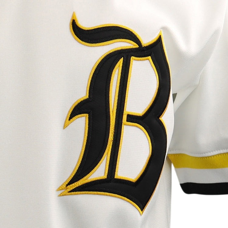 A close-up of the EFF Beeville Blazers EFF Lone Star Baseball Jersey, showcasing a bold black “B” outlined in yellow on the front and yellow-black sleeve stripes, worn during games at Joe Hunter Field.