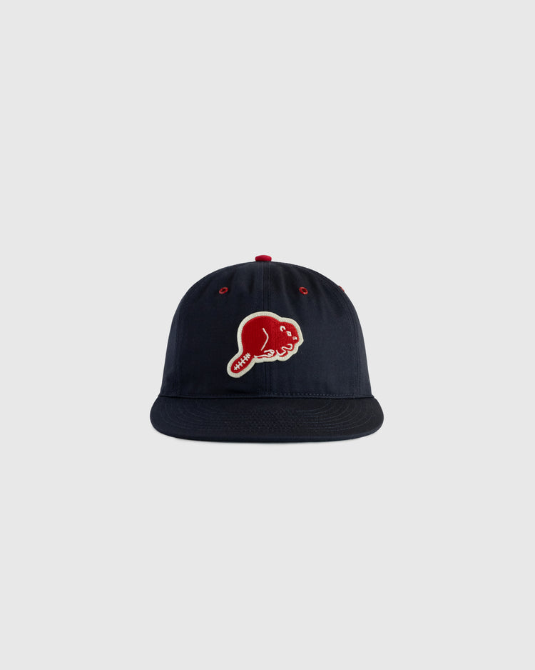 The EFF Portland Beavers Cotton Twill Ballcap in navy features a red and white embroidered fish logo on the front, evoking a vintage style, and is displayed against a plain light gray background.