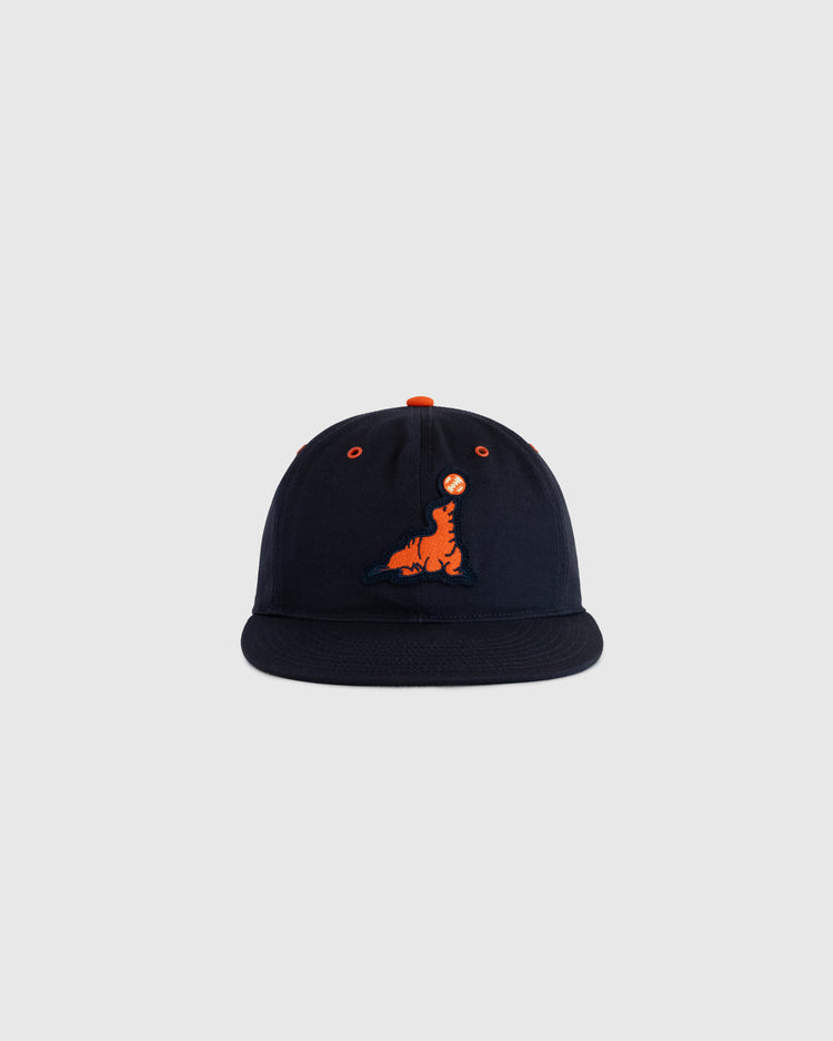 The EFF San Francisco Seals Cotton Twill Ballcap in navy features an orange and blue embroidered dinosaur logo on the front, displayed against a plain light gray background.
