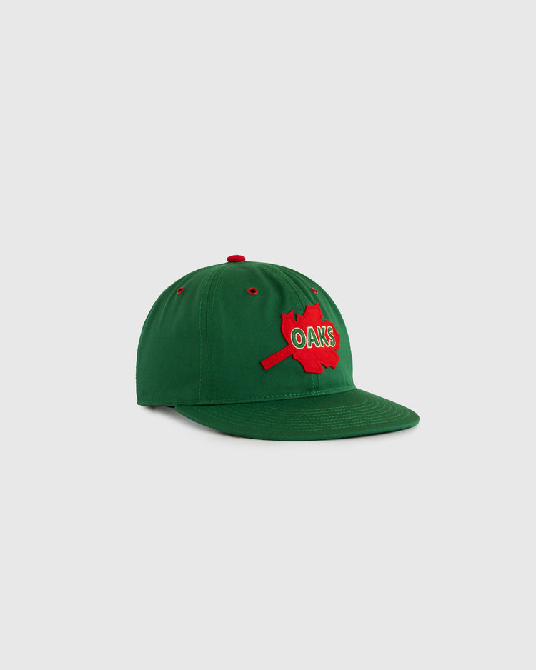 The EFF Oakland Oaks Cotton Twill Ballcap is a vintage green cap featuring OAKS lettering, a red maple leaf patch, red eyelets, and a matching button for classic style.