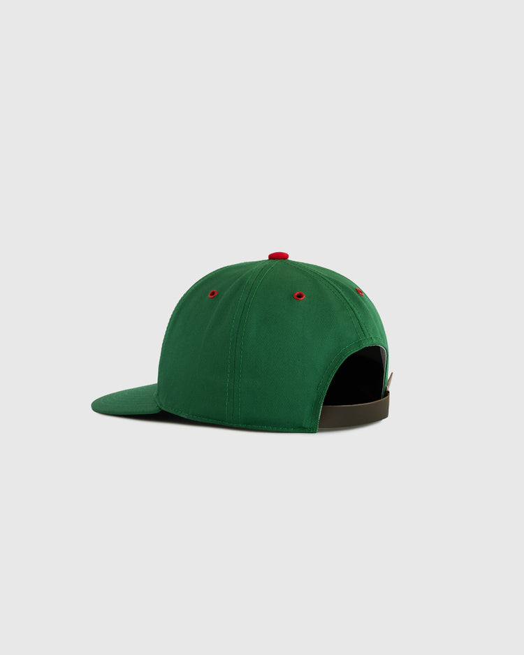 The EFF Oakland Oaks Cotton Twill Ballcap is shown from the back and side in green with red eyelets, a matching top button, adjustable dark strap, and a slightly curved brim, set against a light gray background.