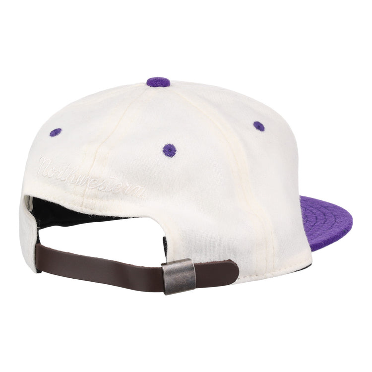 The EFF Northwestern University Vintage Ballcap is a white cap with purple accents and brim, an adjustable brown strap, and Northwestern embroidered above the back—perfect for Wildcats fans seeking vintage Ebbets Field Flannels style.