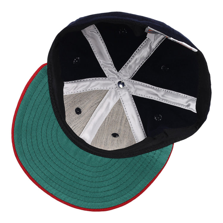 A close-up of the EFF Oklahoma City Indians 1948 Vintage Ballcap reveals a green underbrim, red edge, black interior, and silver stitched strips forming an X—a detailed look inside this classic wool cap.