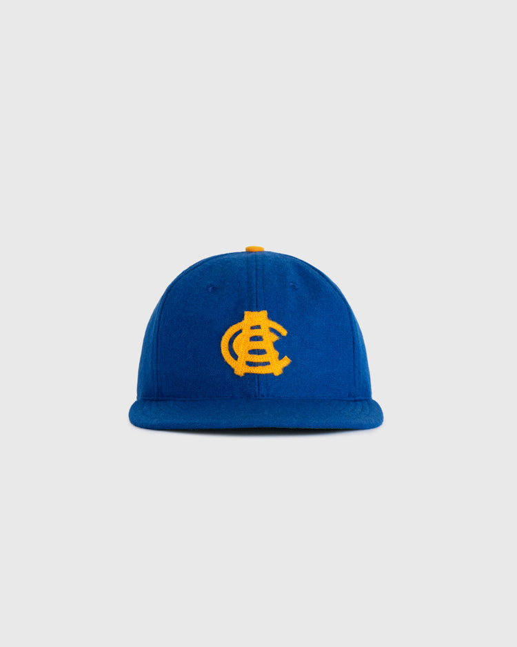 The EFF Chinese Athletic Club (Hawaii) 1910 Authentic Wool Ballcap is a blue cap with a yellow embroidered interlocking C and A logo, inspired by Hawaiian baseball history, shown against a plain light gray background.