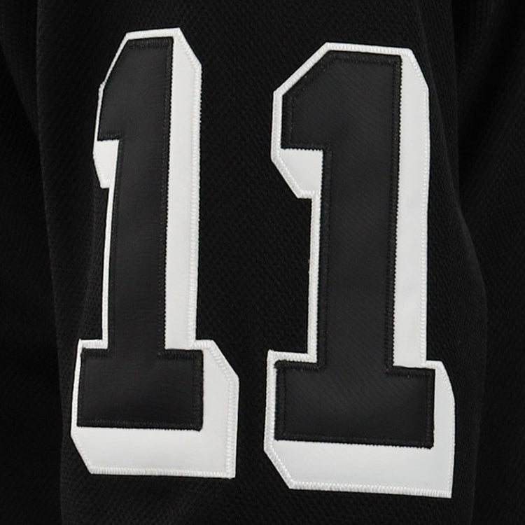 A close-up of black fabric featuring the number 11 in bold white with a black outline, displayed on the EFF Violent Gentlemen x EFF Collection Hockey Jersey.