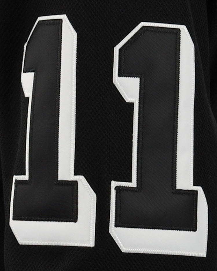 A close-up of black fabric featuring the number 11 in bold white with a black outline, displayed on the EFF Violent Gentlemen x EFF Collection Hockey Jersey.