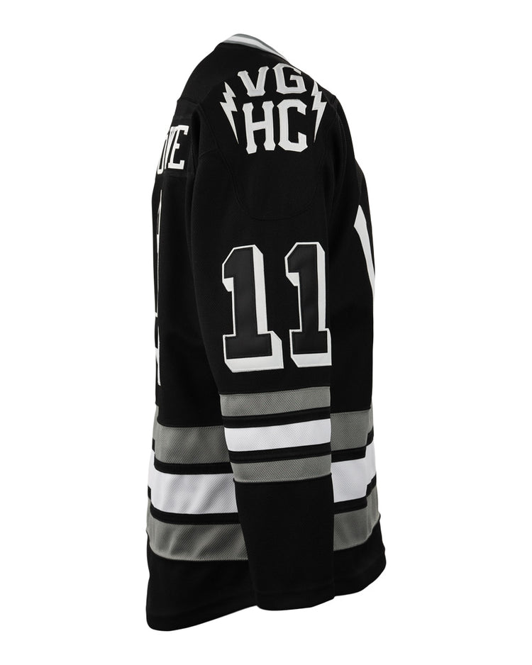 The EFF Violent Gentlemen x EFF Collection Hockey Jersey features a black design with white and gray stripes, number 11 on the right sleeve, and VGK HC with lightning bolts on the upper back—a standout in hockey apparel.