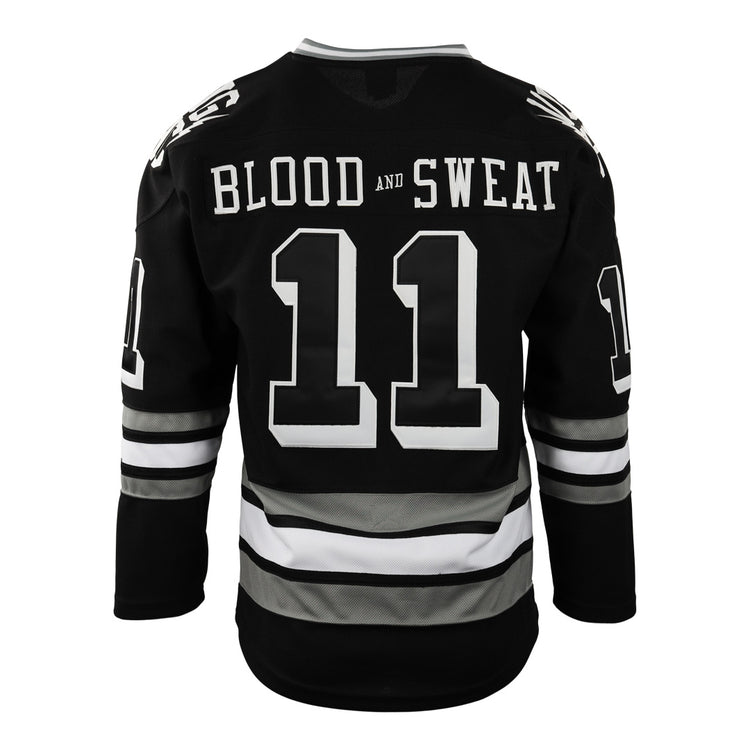 The Violent Gentlemen x EFF Collection Hockey Jersey by EFF is a black hockey jersey with white and gray sleeve and waist stripes. BLOOD AND SWEAT is printed above the large number 11 on the back of this bold piece.