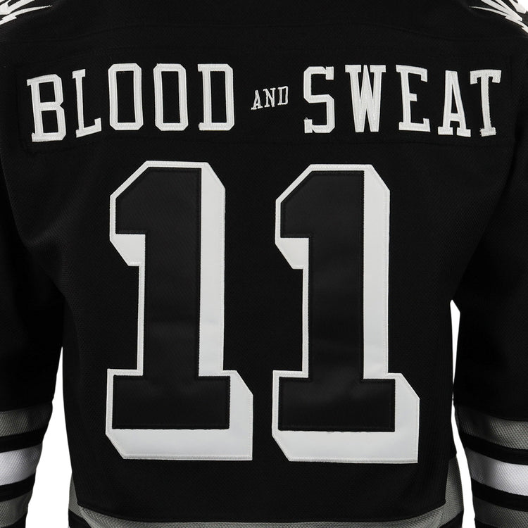 Back of an EFF Violent Gentlemen x EFF Collection Hockey Jersey in black, showing a large white number 11 and BLOOD AND SWEAT in bold white letters across the upper back, inspired by classic Violent Gentlemen designs.