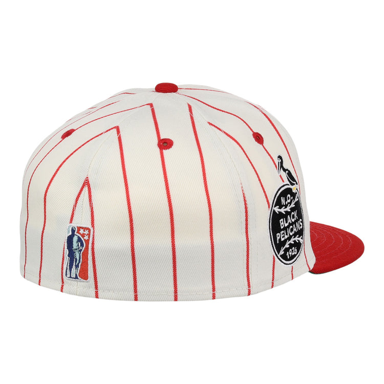 The EFF New Orleans Black Pelicans NLB Pinstripe Fitted Ballcap features red pinstripes, a red brim, a round BLACK PELICANS 1924 patch honoring the Negro Southern League team, plus embroidered figure and pelican accents on the side.