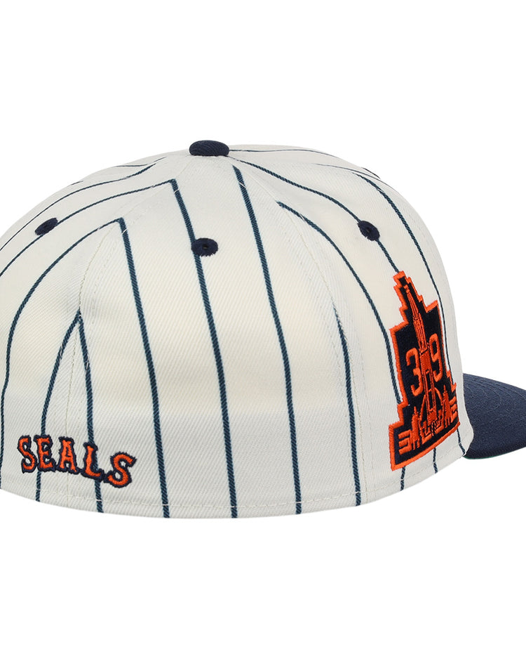 The EFF San Francisco Seals Pinstripe Fitted Ballcap features a white base with navy pinstripes, a navy brim, orange SEALS text on the back, and a large orange 319 cityscape patch—celebrating the iconic team.