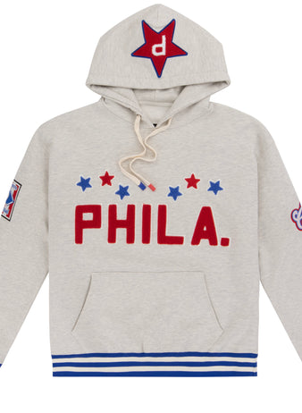 The EFF Cultural Excellence x Philadelphia Stars French Terry Hooded Sweatshirt features light gray streetwear style with red PHILA., blue and red stars, blue-striped cuffs, a star-detailed hood, and a sleeve patch—honoring Negro League legends.
