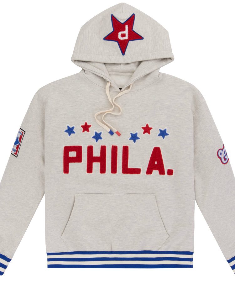 The EFF Cultural Excellence x Philadelphia Stars French Terry Hooded Sweatshirt features light gray streetwear style with red PHILA., blue and red stars, blue-striped cuffs, a star-detailed hood, and a sleeve patch—honoring Negro League legends.
