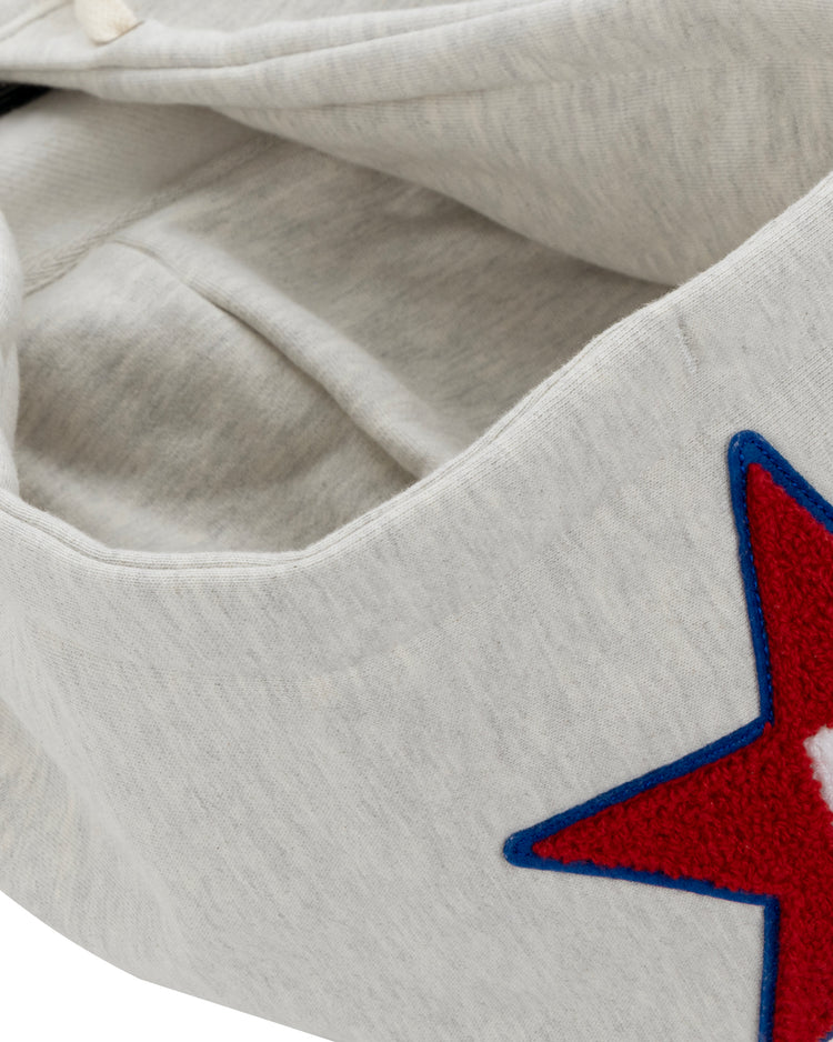 A close-up of the EFF Cultural Excellence x Philadelphia Stars French Terry Hooded Sweatshirt in light gray, with a red star outlined in blue and a white A on the outside, inspired by the iconic Negro League Baseball team.
