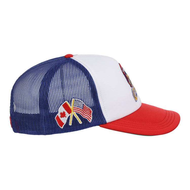 The EFF Calgary Cannons EFF MiLB Vintage Foam Trucker is a blue and white hat with a red brim, featuring crossed Canadian and American flags embroidered on the side mesh—honoring the Pacific Coast League’s Calgary Cannons.