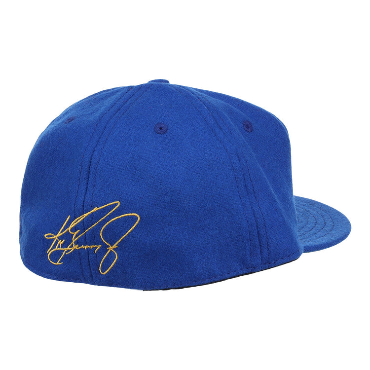 The Ebbets Field Flannels Ken Griffey Jr. 1989 Signature Series Ballcap is shown from the back in royal blue wool, with visible stitching, top eyelets, and a yellow embroidered signature on the left side.