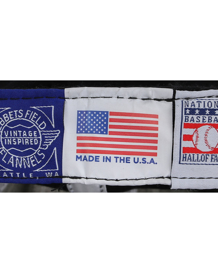 Close-up of three tags: Ebbets Field Flannels, Made in the U.S.A., and National Baseball Hall of Fame—a perfect detail for fans of the Harmon Killebrew Signature Series Ballcap by Ebbets Field Flannels.