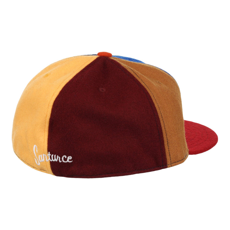 The EFF Santurce Cangrejeros Vintage Inspired Pinwheel Ballcap features yellow, burgundy, and blue panels with a red brim and Lafayette in white—paying tribute to Roberto Clemente’s legendary team.