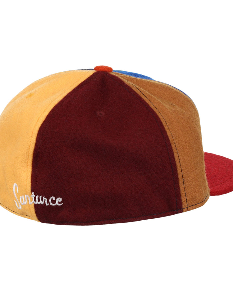 The EFF Santurce Cangrejeros Vintage Inspired Pinwheel Ballcap features yellow, burgundy, and blue panels with a red brim and Lafayette in white—paying tribute to Roberto Clemente’s legendary team.