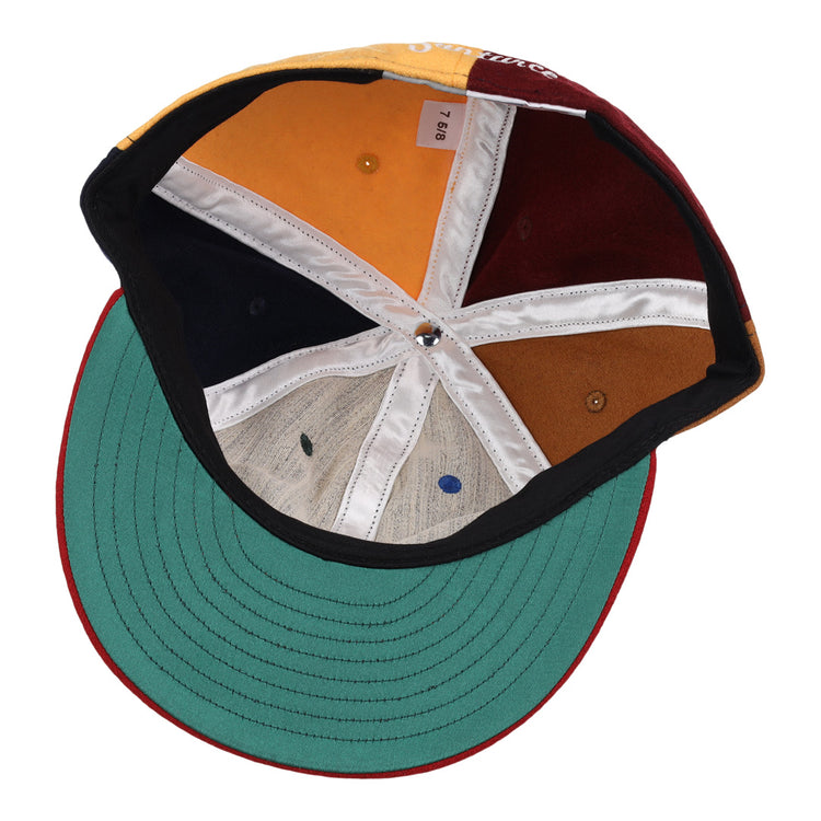 The EFF Santurce Cangrejeros Vintage Inspired Pinwheel Ballcap features a green brim underside and multi-colored panels—yellow, orange, white, navy blue, brown, beige—divided by crisp white seams for a classic Santurce look.