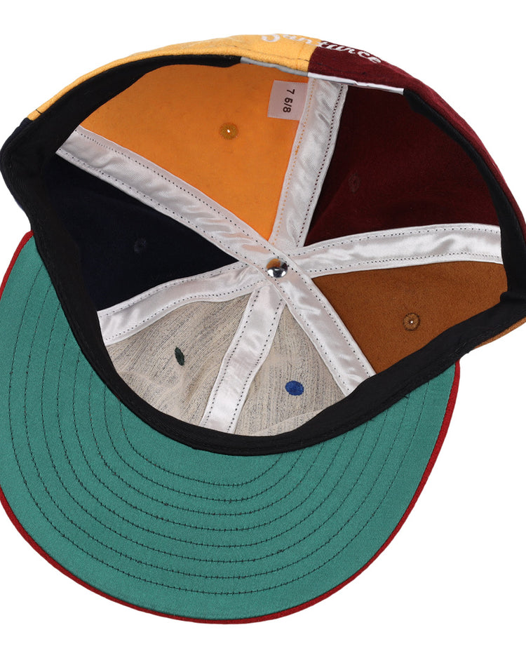 The EFF Santurce Cangrejeros Vintage Inspired Pinwheel Ballcap features a green brim underside and multi-colored panels—yellow, orange, white, navy blue, brown, beige—divided by crisp white seams for a classic Santurce look.
