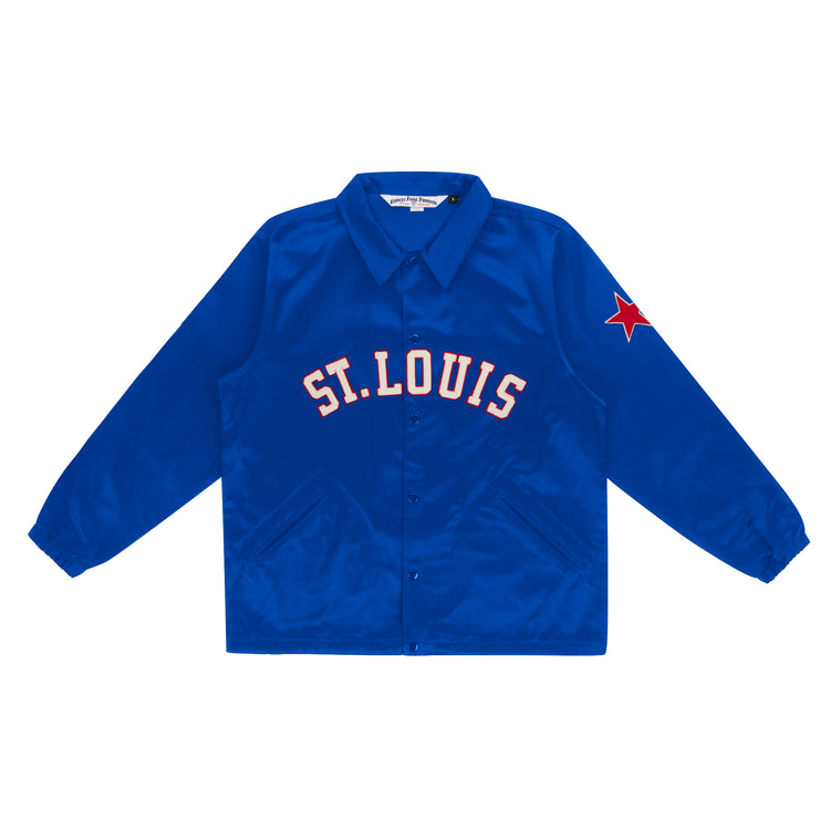 The EFF St. Louis Stars Satin Windbreaker is a bright blue jacket inspired by vintage windbreakers, featuring ST. LOUIS in bold white and red across the chest and a red star patch on the left sleeve.