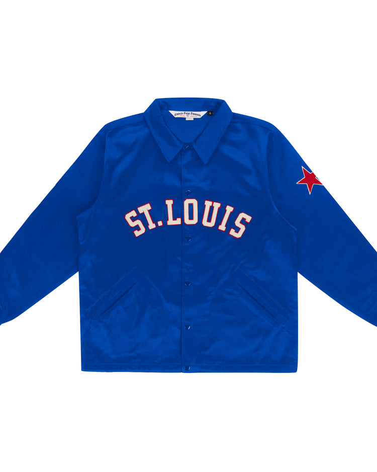 The EFF St. Louis Stars Satin Windbreaker is a bright blue jacket inspired by vintage windbreakers, featuring ST. LOUIS in bold white and red across the chest and a red star patch on the left sleeve.