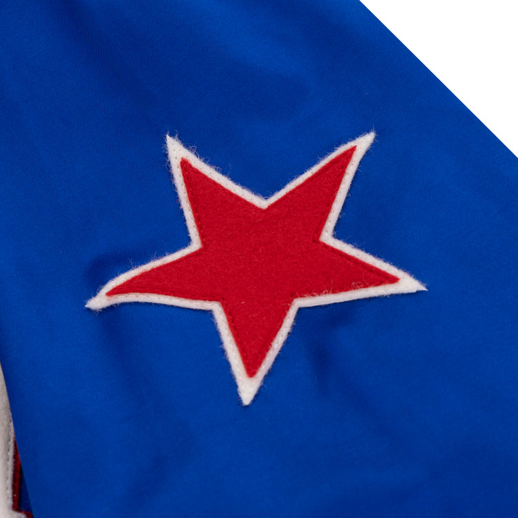 A red star with a white border is sewn onto bright blue satin, evoking vintage style in the EFF St. Louis Stars Satin Windbreaker.