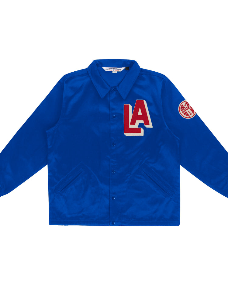 The EFF Los Angeles (PCL) Satin Windbreaker is royal blue with a button-up front, collar, bold red and white LA chest patch, and round red patch on the upper left sleeve—classic Pacific Coast League style.