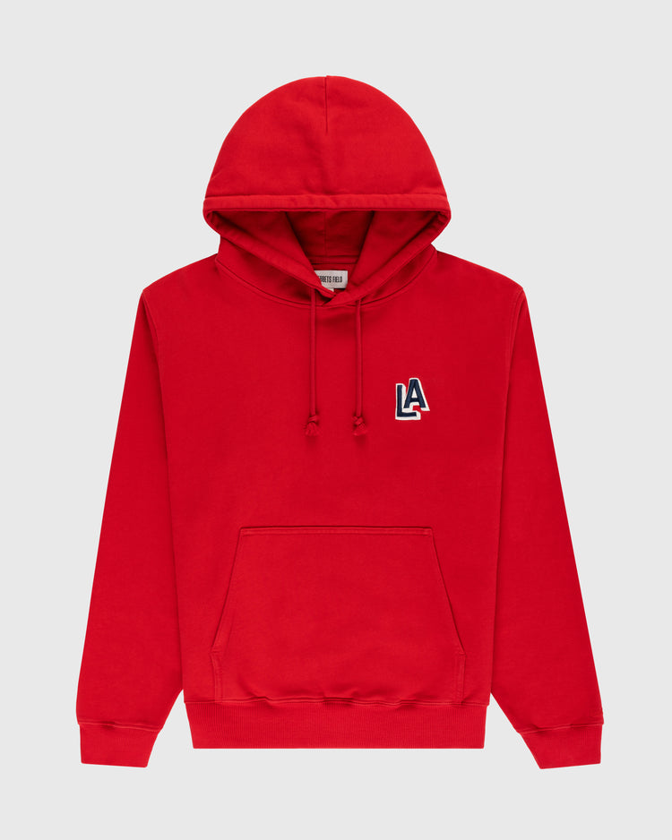 The Ebbets Field Los Angeles Angels (PCL) Heavyweight Cotton Terry Pullover Hoodie is a bright red hoodie with a front pouch pocket and a vintage 1942 LA logo patch on the upper left chest.