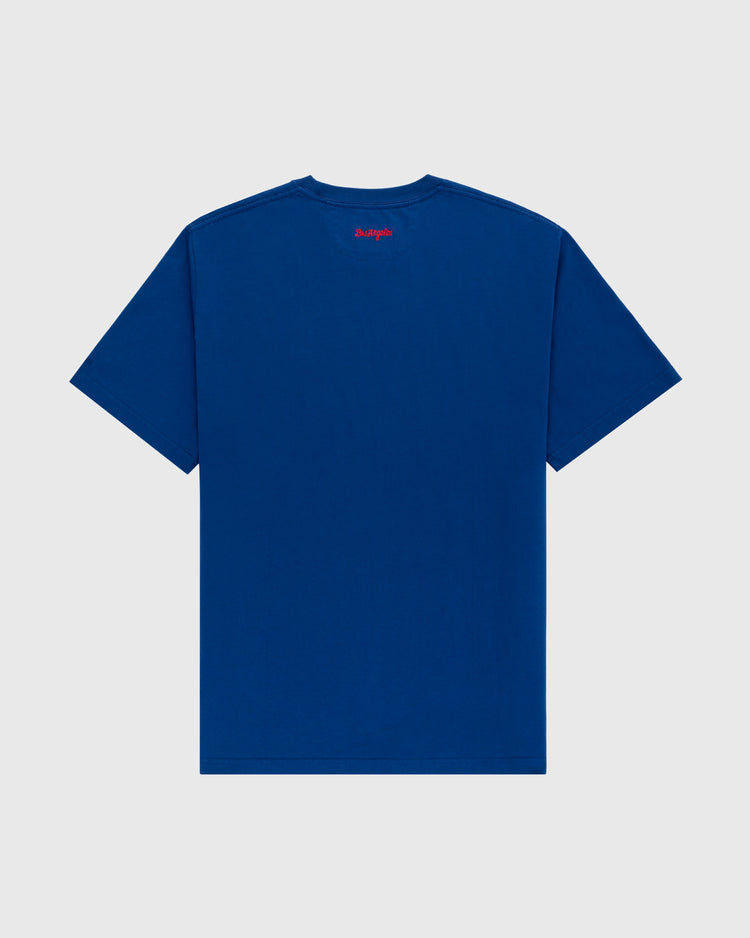 The Los Angeles Angels (PCL) Embroidered ‘LA’ Short Sleeve Tee by Ebbets Field is shown from the back, with subtle red text near the neckline. The classic blue design reflects Ebbets heritage and is set against a light gray background.
