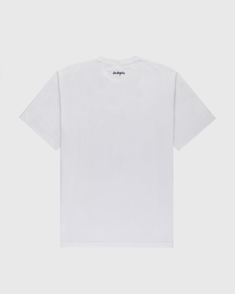 Back of the Los Angeles Angels (PCL) Embroidered ‘LA’ Short Sleeve Tee by Ebbets Field in plain white, with a small black ‘LA’ logo near the neckline, shown against a light gray background.