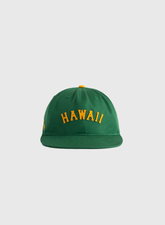 The Ebbets Field Hawaii Islanders (PCL) Cotton Twill Ballcap is a green vintage-style hat with HAWAII embroidered in yellow on the front, inspired by classic Islanders designs and shown on a plain light gray background.
