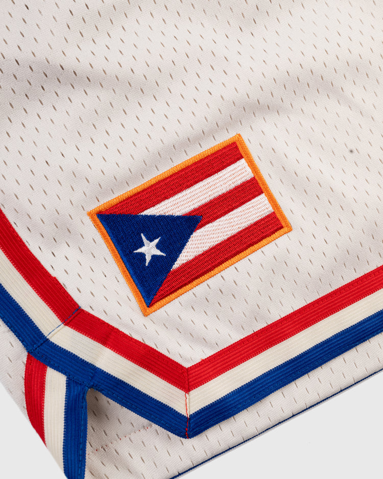 A close-up of Ebbets Field Santurce Cangrejeros Mesh Shorts featuring a stitched Puerto Rican flag patch and red, white, and blue trim, inspired by Roberto Clemente and Puerto Rican baseball legacy.
