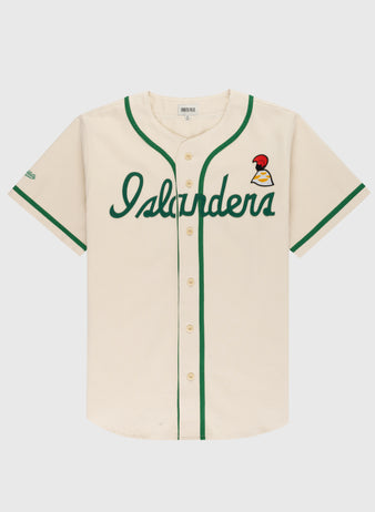 The Ebbets Field Hawaii Islanders (PCL) Cotton Twill Baseball Jersey features cream cotton twill, green trim, “Islanders” in green script on the front, a red and yellow bird patch on the left chest, and a classic button-up front.