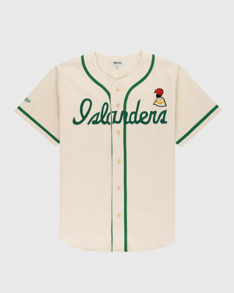 The Ebbets Field Hawaii Islanders (PCL) Cotton Twill Baseball Jersey features cream cotton twill, green trim, “Islanders” in green script on the front, a red and yellow bird patch on the left chest, and a classic button-up front.