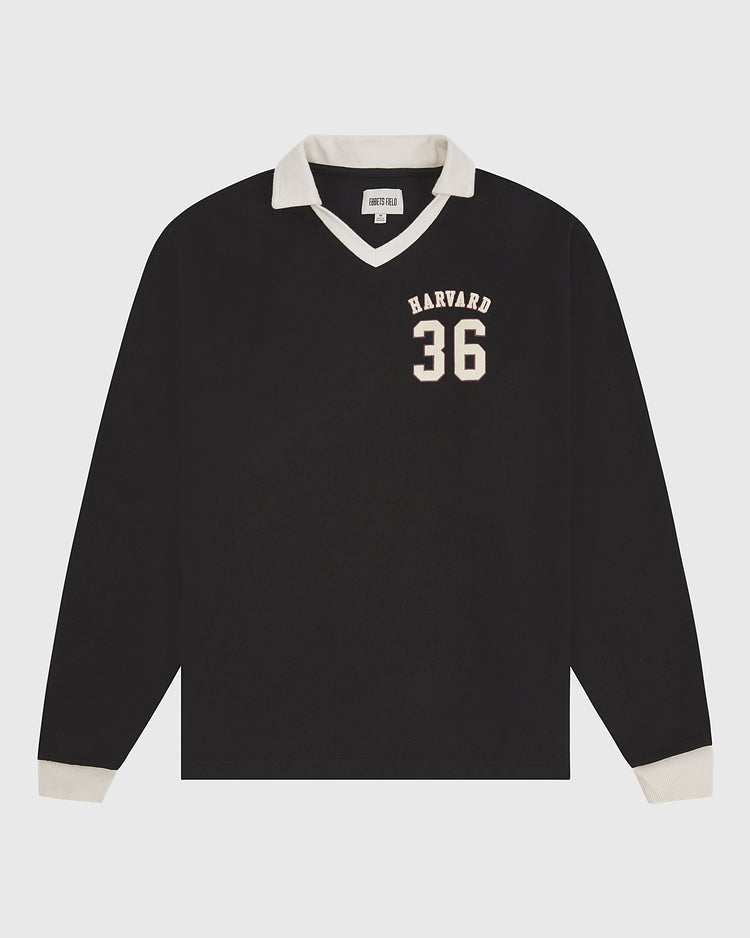 The Ebbets Field Harvard University Vintage Soccer Goalie Jersey is a black long-sleeve shirt with a white collar and cuffs, featuring “HARVARD 36” in white on the left chest. The jersey is displayed flat on a plain white background.