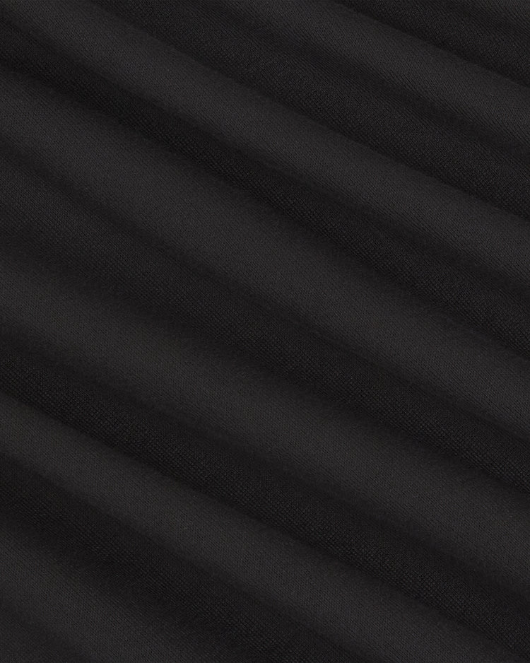 Close-up of the Harvard University Vintage Soccer Goalie Jersey by Ebbets Field, showcasing black fabric with diagonal ribbed texture that creates subtle shadowed lines across the surface.