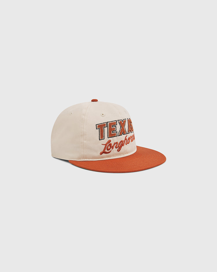 The Ebbets Field University of Texas Longhorns Cotton Twill Ballcap, featuring beige and burnt orange colors with TEXAS and Longhorns embroidered on the front, is displayed on a plain white background.