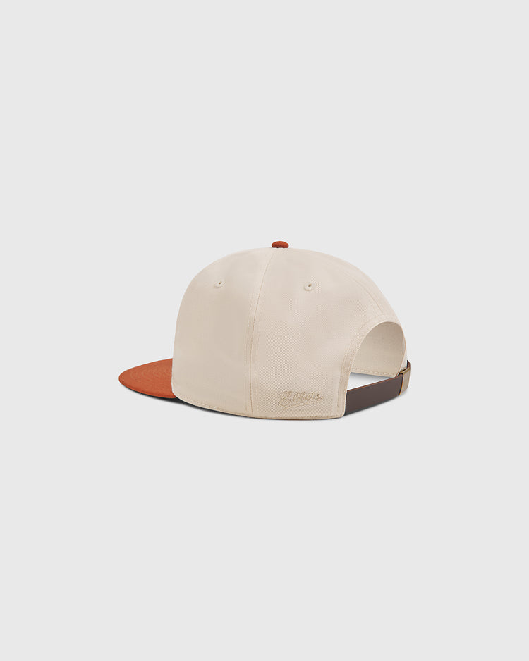 The Ebbets Field University of Texas Longhorns Cotton Twill Ballcap features a beige body, a brown brim, and an adjustable strap at the back. Displayed against a plain white background, it’s the ideal accessory for dedicated Longhorns fans.